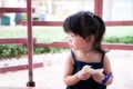 Hungry AsianÃ¢â¬â¹ childÃ¢â¬â¹ girlÃ¢â¬â¹Ã¢â¬â¹ use her hand eatingÃ¢â¬â¹ someÃ¢â¬â¹ sandwich bread byÃ¢â¬â¹ herself.Ã¢â¬â¹